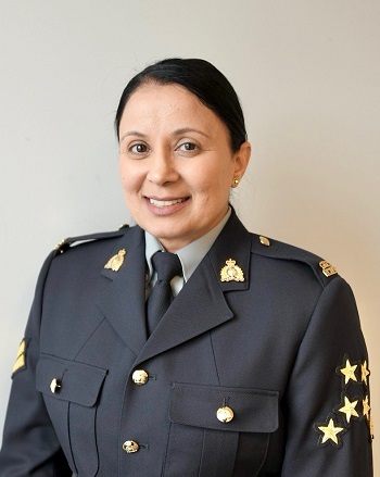 Cpl. Dhesi wearing a blue Serge uniform. 